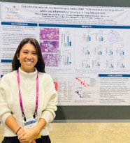 Nhat Hoang standing next to her research poster