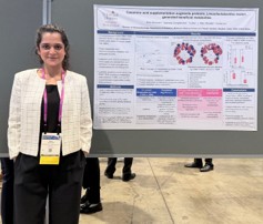 Rida Sherwani standing next to her research poster
