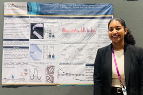 Melissa Munroe standing next to her research poster