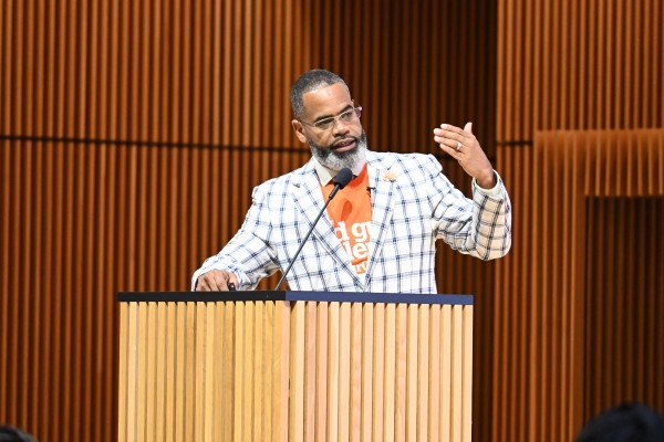 Karlton Harris speaking at podium