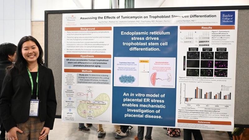 Kay Chi Pua stands in front of research poster
