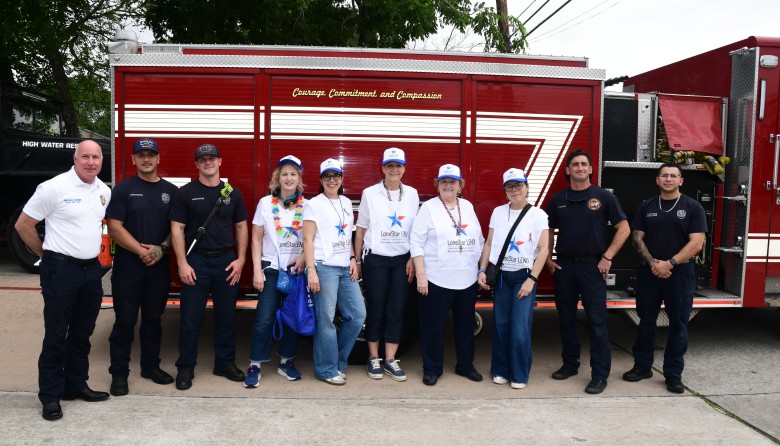 Group of firefighters and coordinators in front of fire truck