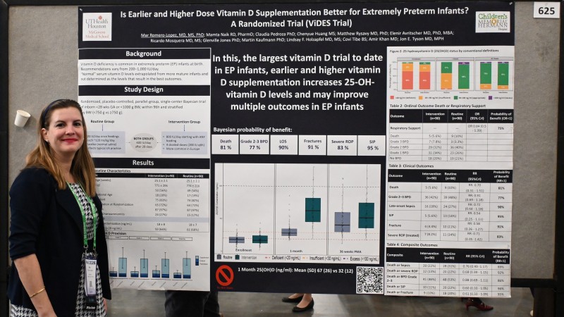 Dr. Romero Lopez stands in front of her research poster.