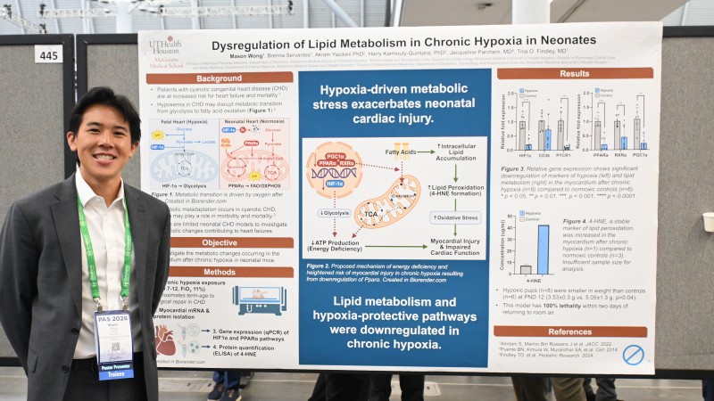 Mason Wong stands in front of research poster