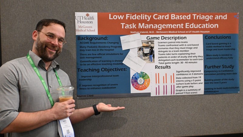 Dr. Valenti proudly displays his research poster.