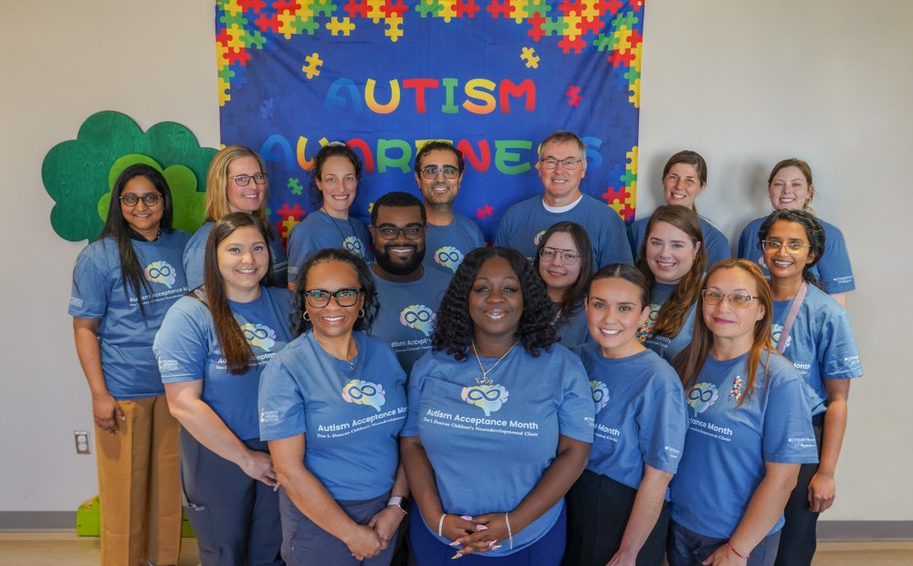 Group of clinic staff in blue shirts for autism awareness month