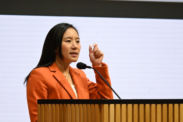 Dr. Tran speaking at podium