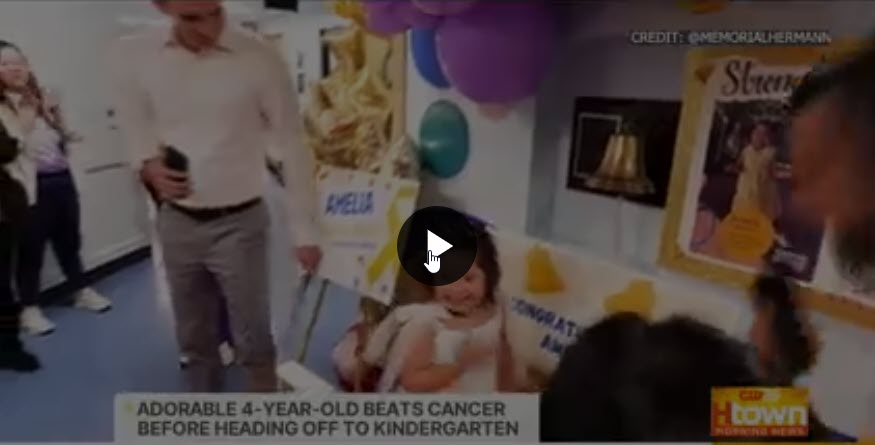 Screenshot of video of Amelia smiling after ringing the bell