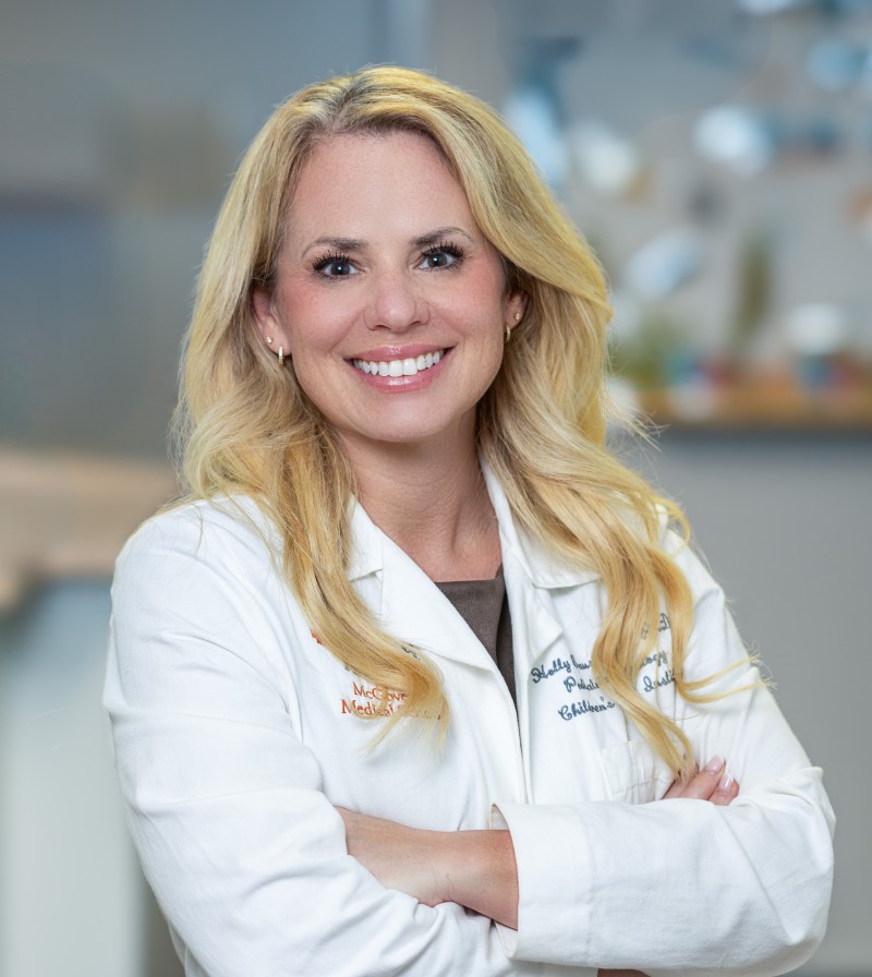 Holly Bauser-Heaton, MD, PhD, in white coat