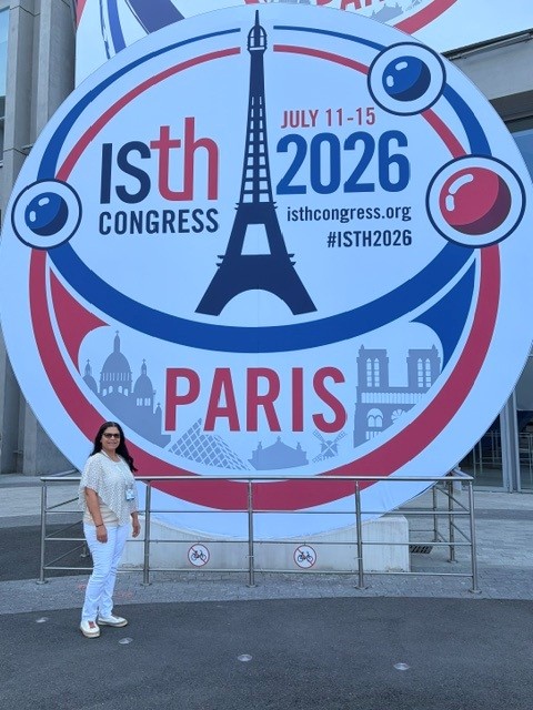Dr. Rodriguez in front of ISTH sign