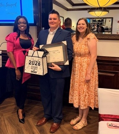 Dr. Moody and Dr. Wilson stand with Dr. Sargent