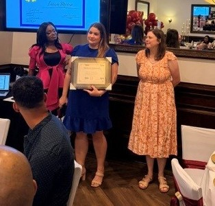 Dr. Moody and Dr. Wilson give award to graduating resident
