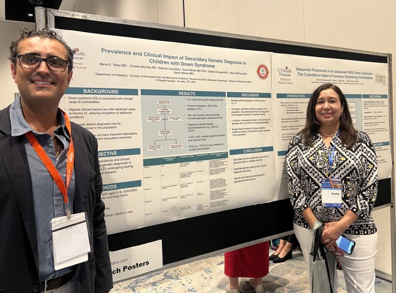 Dr. Anzueto and Dr. Tellez stand next to their research poster