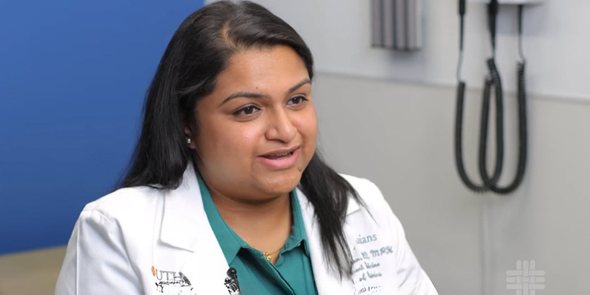 Doctor in white coat in clinic room being interviewed