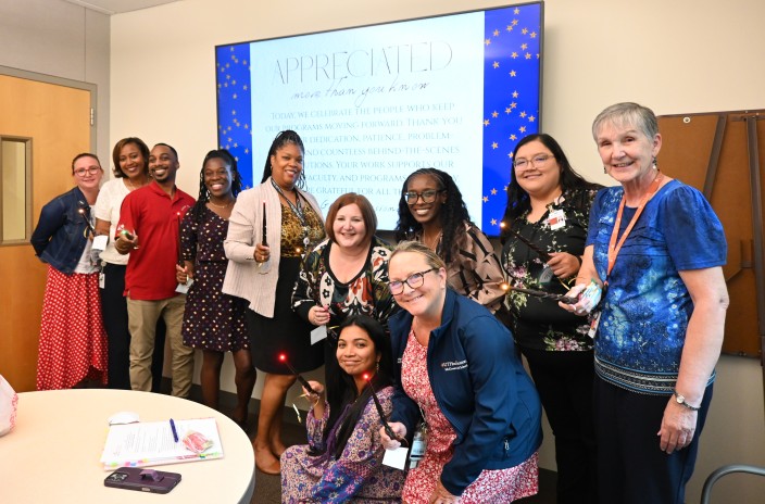 Group of GME professionals holding magic wands