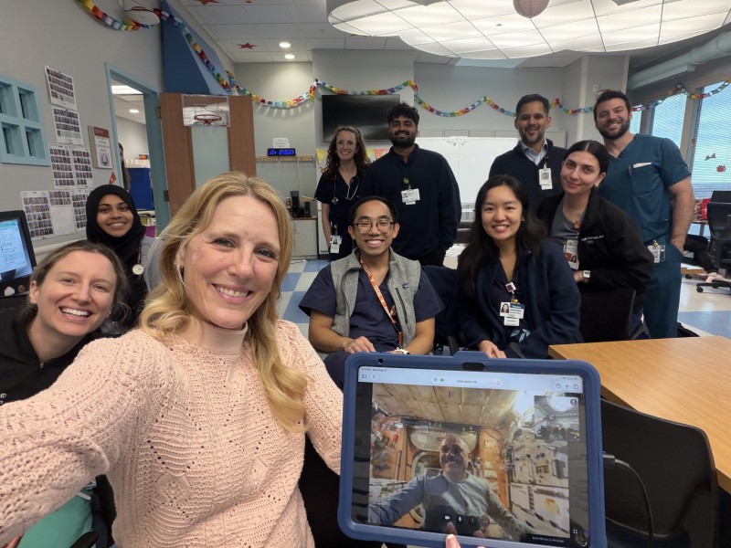 Selfie of Dr. Marshburn and PHM trainees on virtual call with an astronaut