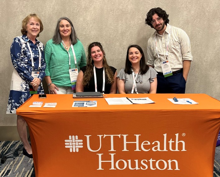Members of the TSC team stand behind UTHealth Houston table