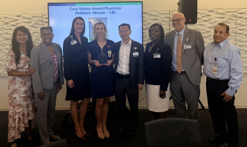 Group of people with Dr. Guardiola holding award