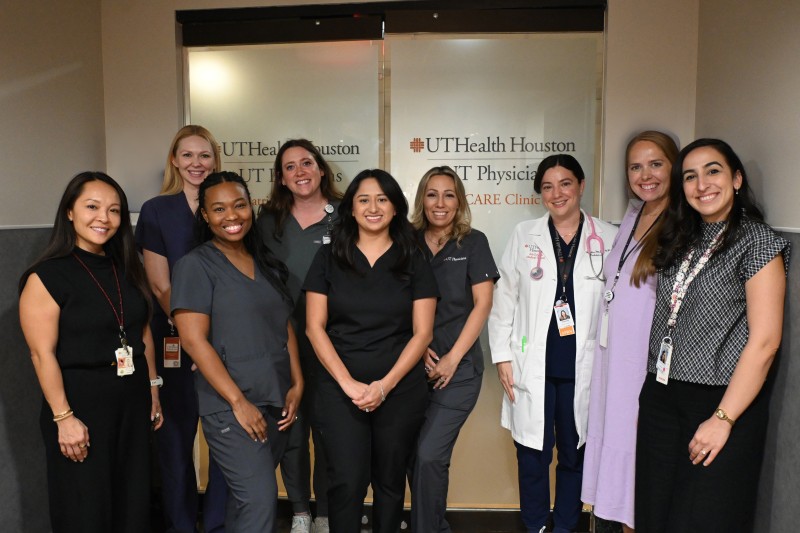 CARE Clinic team in front of clinic door
