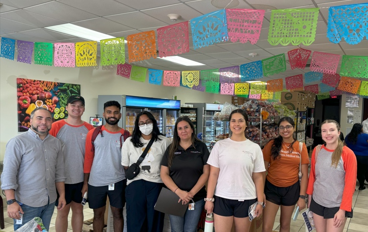 group photo of students at Tejano Center's La Tiendita (Food Pantry).