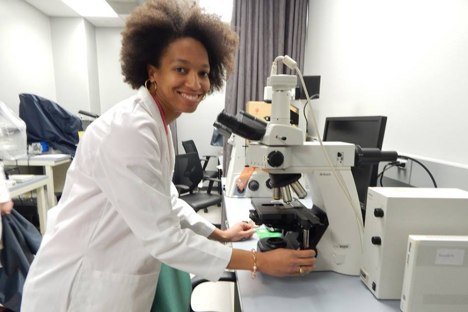 researcher in the lab using microscope
