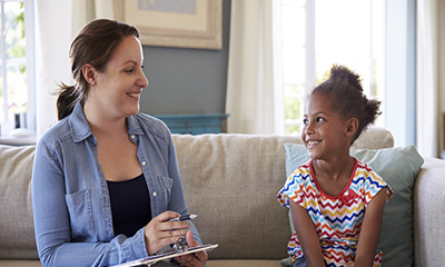 Young Girl Talking With Counselor At Home interview