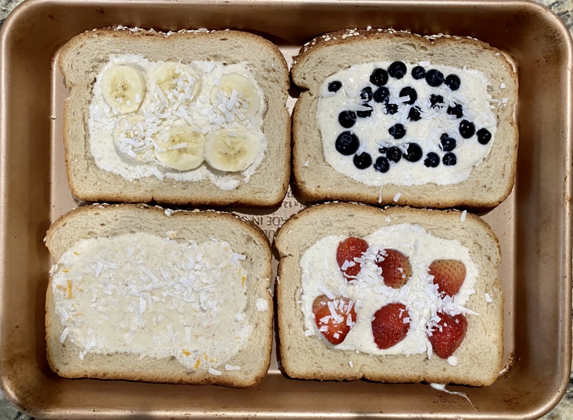 Baking pan containing 4 pieces of custard toast, each with a different topping