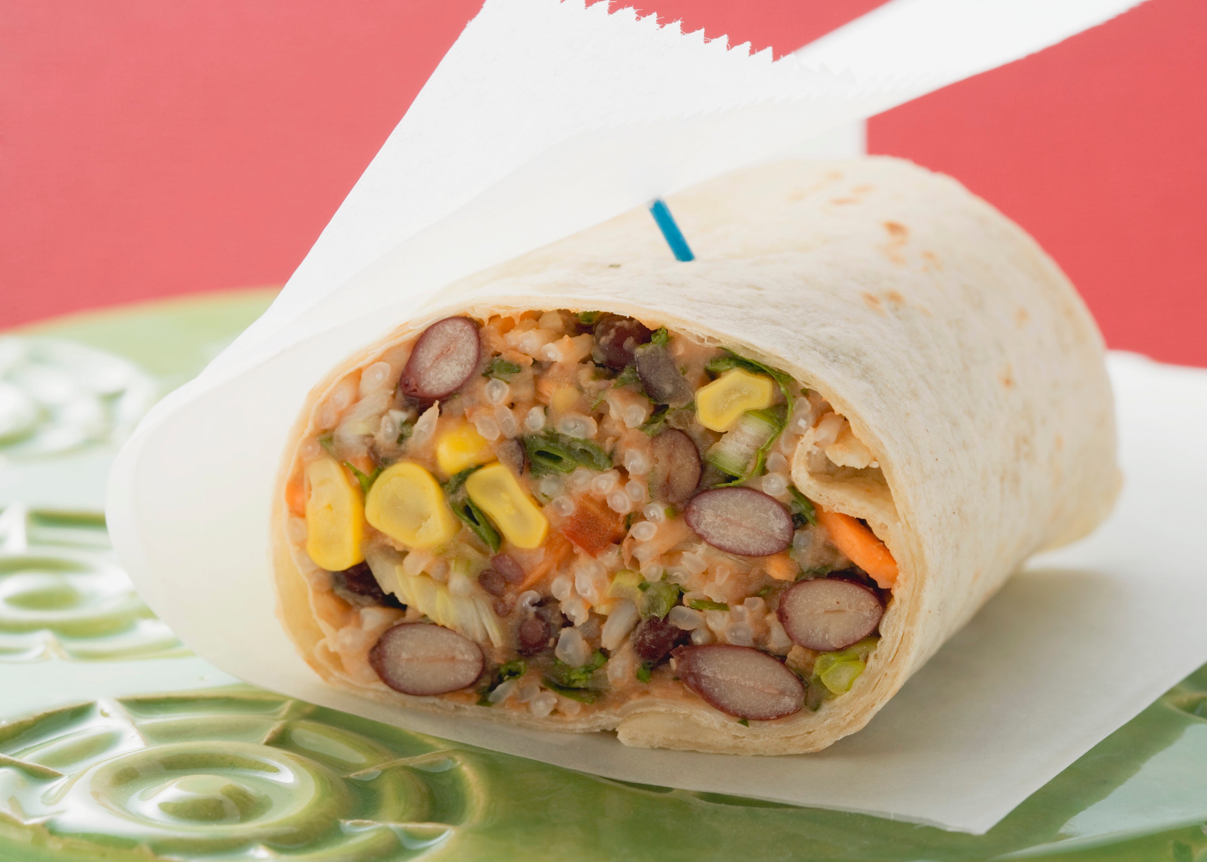 Tortilla rollup filled with beans, corn, rice, and salsa