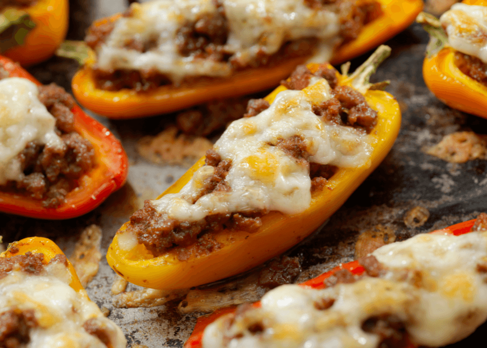 Yellow and red mini peppers stuffed with ground meat and cheese