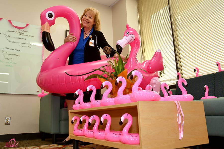 Dr. Mary Aitken with pink flamingos
