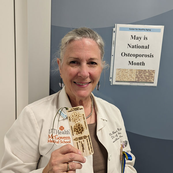 Dr. Maureen Beck with the osteoporosis bookmark she designed