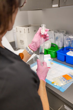 Nurse filling a syringe 