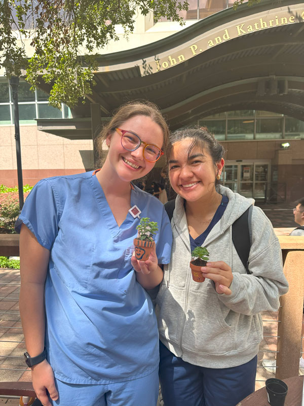 Posing with the pots created at the studetn wellness fair