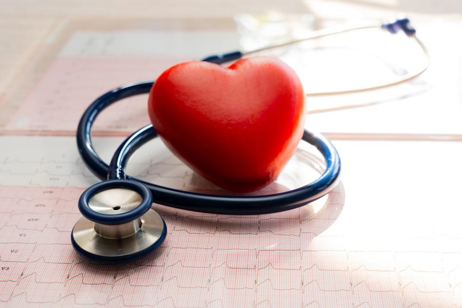 A heart surrounded by a stethoscope