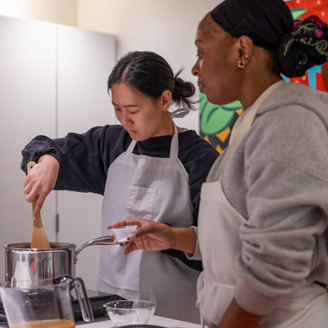 McGovern Medical School students practice cooking techniques at the culinary medicine program.