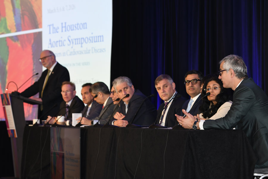 A group of doctors holding a panel discussion at the Aortic Symposium.