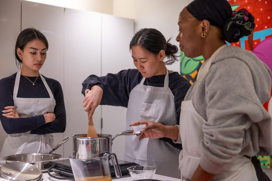 Three McGovern Medical School students practice their cooking skills as part of the Culinary Medicine Program