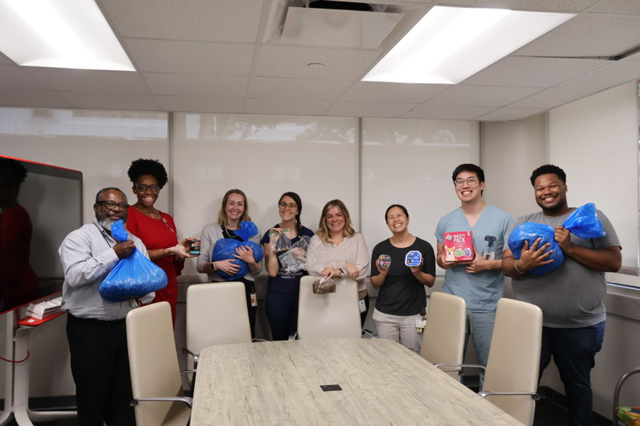 Volunteers pack dry dog and cat food for donation to AniMeals
