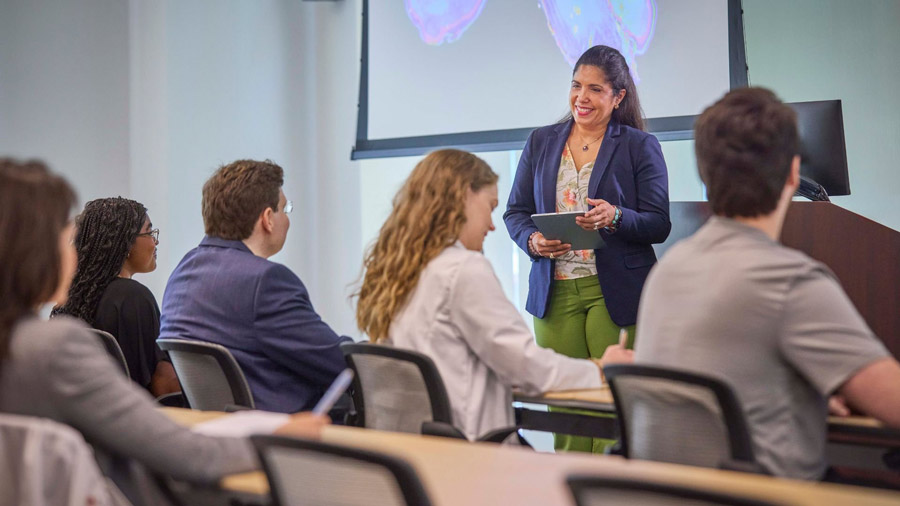 A teacher stands in front of a class teaching students about forensic psychiatry