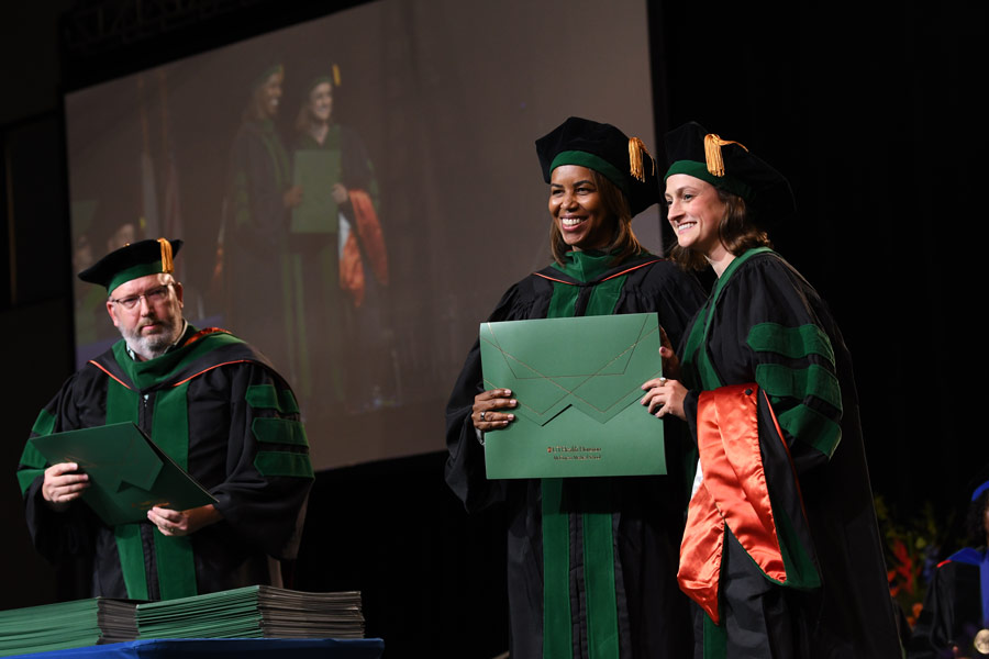 LaTanya J. Love, MD, poses with a graduate after presenting a diploma during the McGovern Medical School Class of 2026 Commencement Ceremony.