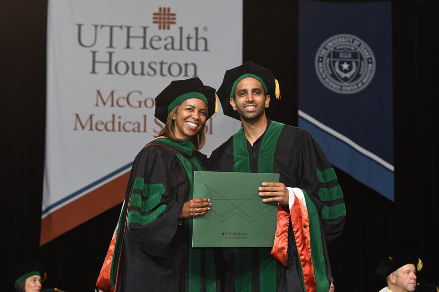 LaTanya J. Love, MD, poses with a graduate holding a diploma cover during the McGovern Medical School Class of 2026 Commencement Ceremony.