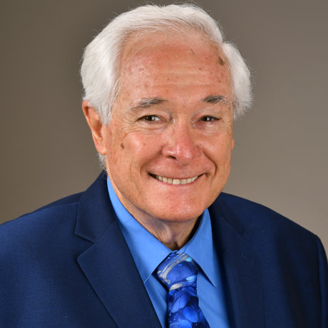 Dr. Charles Ericsson in a blue suit with a blue tie and blue button up shirt