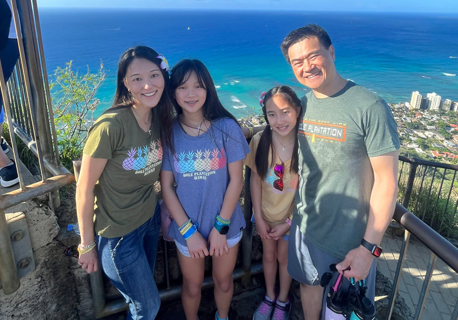 Dr. Peggy Hsieh and her family pose for a photo in front of the ocean.