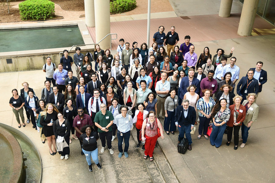 Faculty, staff, and students gather outdoors for a large group photo during a UTHealth Houston retreat event.
