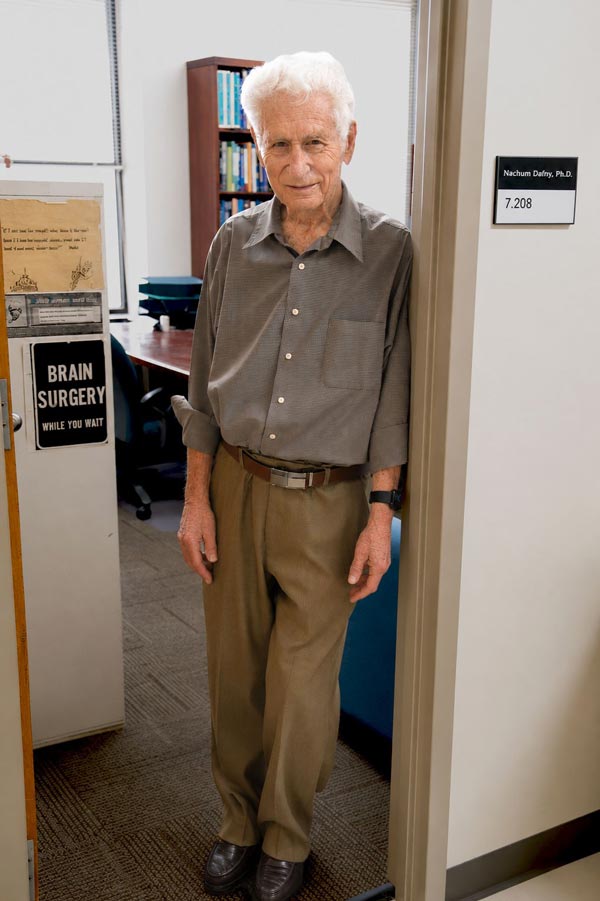 Dr. Nachum Dafney stands in the doorway of his office after celebrating his retirement after 54 years at McGovern Medical School at UTHealth Houston