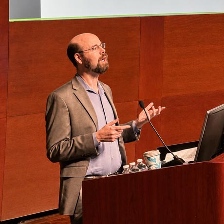 Dr. Sean Savitz presents at a lectern with the UTHealth Houston logo at the annual Yatsu Day Symposium