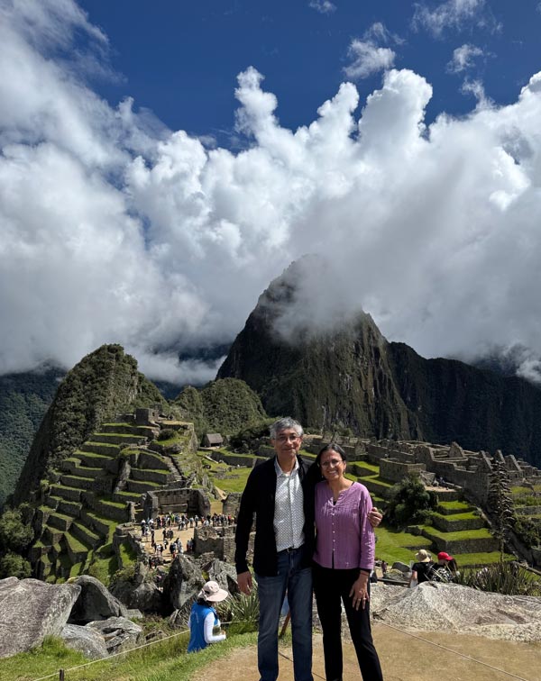 Vasanthi Jayaraman, PhD, and her husband, Ramanan Krishnamoorti, PhD, pose together overlooking the ancient stone terraces and mountainous landscape of Machu Picchu in Peru.