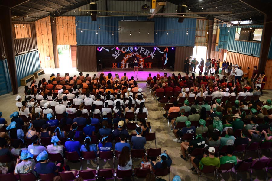 McGovern Medical School students gather by team colors inside a large hall for a group activity during the Henry W. Strobel Retreat.