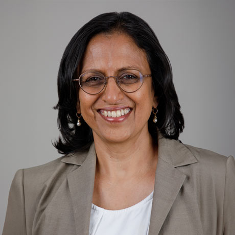 Dr. Vasanthi Jayaraman poses for a professional headshot with a brown jacket and white shirt