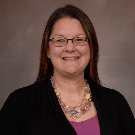 Dr. Sandray McKay poses for a professional headshot with a black shirt
